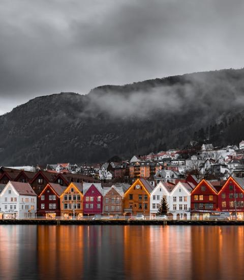 Official Statistics: Colored houses on black and white lake and mountains in Bergen Norway
